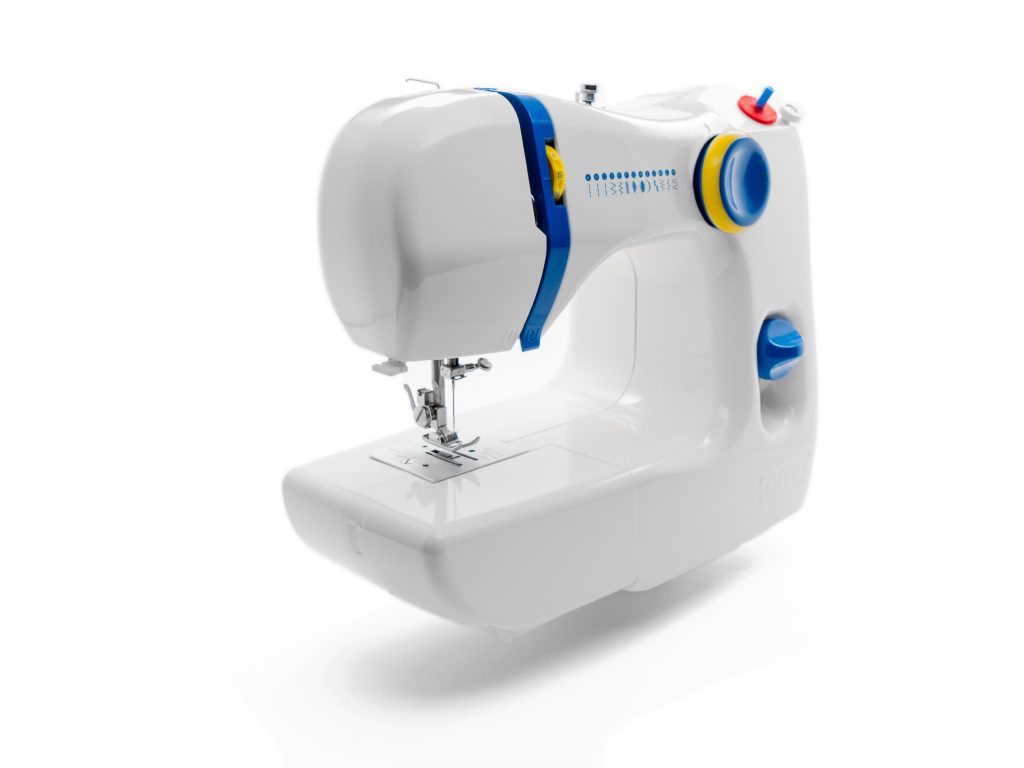 White sewing machine against white background
